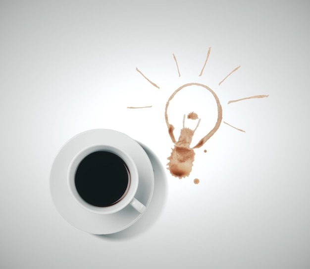 Cup of coffee and drawing light bulb