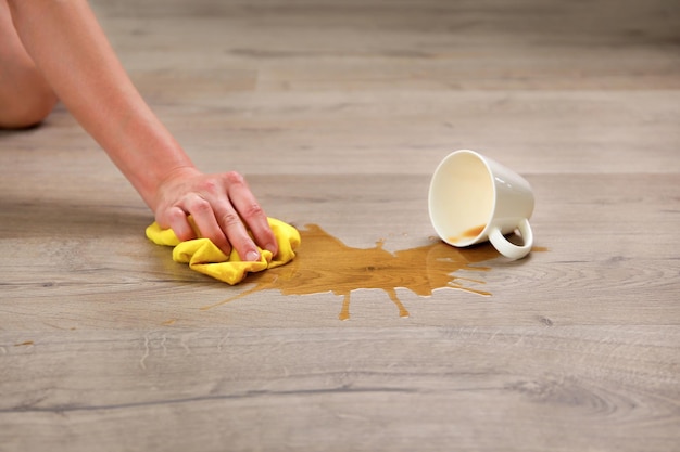 A cup of coffee fell on laminate coffee spilled on floor