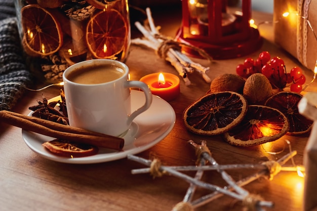 Cup of coffee in festive decorations with a fairy garland lights