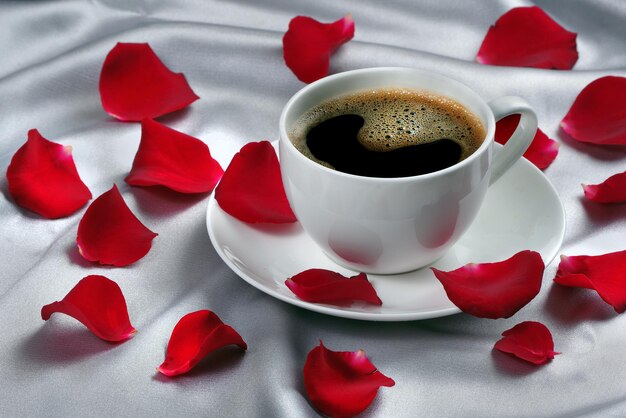 a cup of coffee and a flower petals on a table