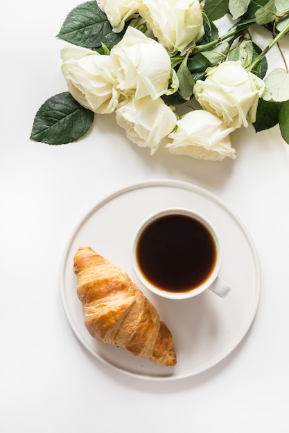 Cup of coffee and freshly baked croissants. Top view. Copy space.