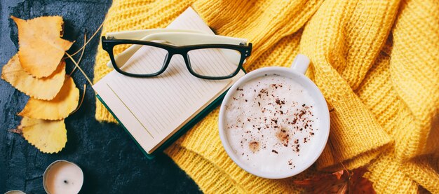 Cup of coffee, glasses and a bright yellow sweater