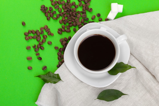 Cup of coffee on green background.