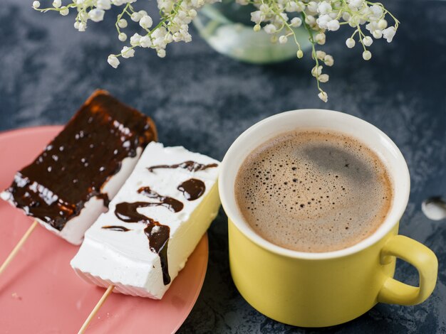 A Cup of coffee and homemade marshmallows . Delicious dessert