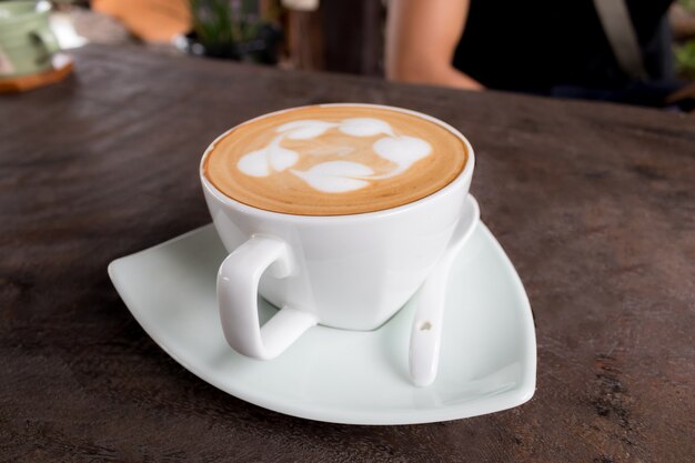 Photo cup of coffee hot on wooden table