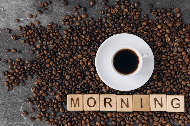 A cup of coffee and the inscription good morning on wooden cubes