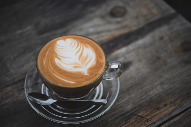 Foto latte della tazza di caffè sulla barra di legno