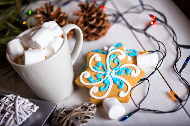 Cup of coffee and marshmallows. gingerbread and Christmas decorations