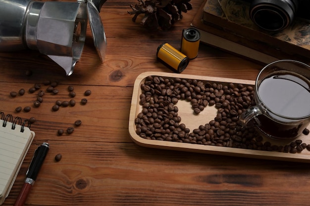 Cup of coffee moka pot and  roasted coffee beans on wooden table