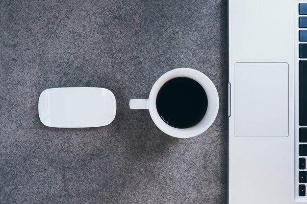 cup of coffee on old wooden desk. 