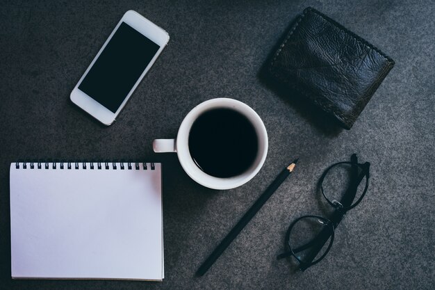 cup of coffee on old wooden desk. 