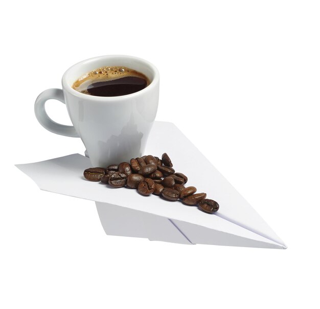 Cup of coffee on a paper plane isolated on white background. Conceptual photo