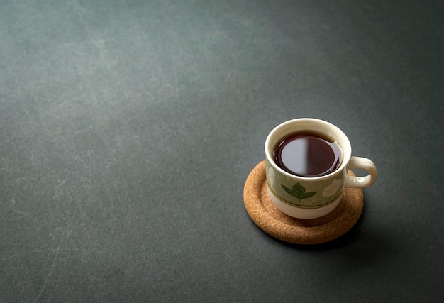 Cup of coffee on rustic black tabletop