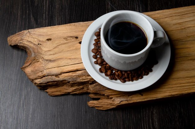 Cup of coffee on a rustic wood Coffee grains