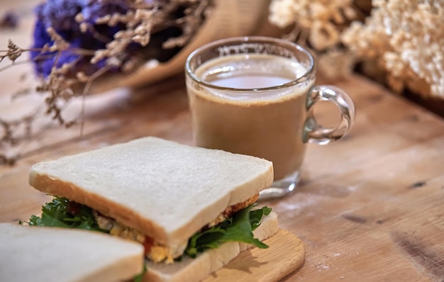 A cup of coffee and a sandwich on a table