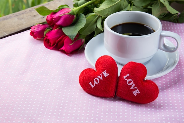 Foto tazza di caffè, forma cuore testo amore e rosa