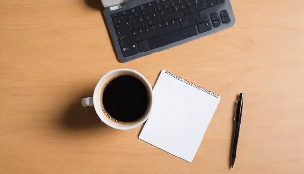 Photo a cup of coffee sits next to a notebook with a pen and pen on it