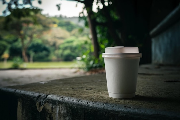Photo a cup of coffee sits on a stone ledge
