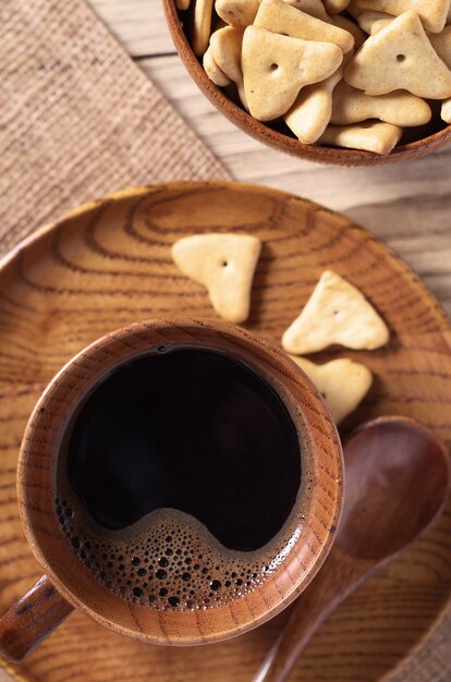 Cup of coffee and small cookies close-up