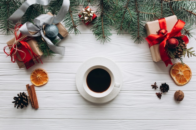 Cup coffee, smartphone and wrapping christmas gifts.