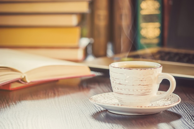 A cup of coffee and a smoke good morning at the office at work. Selective focus.