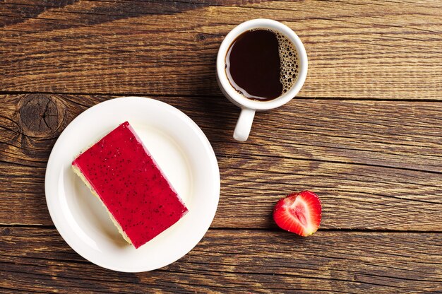 Cup of coffee and strawberry cake on the table