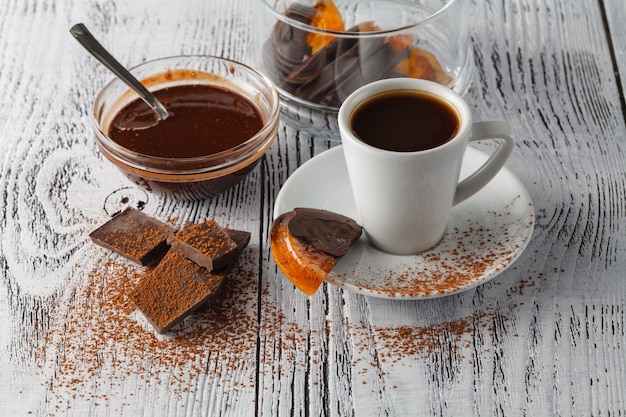 Cup of coffee and sweets on a white background