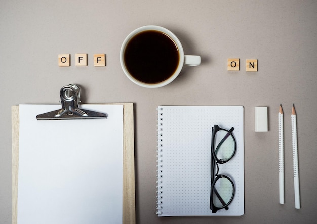 Cup of coffee switching on and stationery Top view flat lay