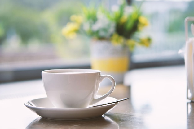 Cup of coffee on table in cafe Morning light