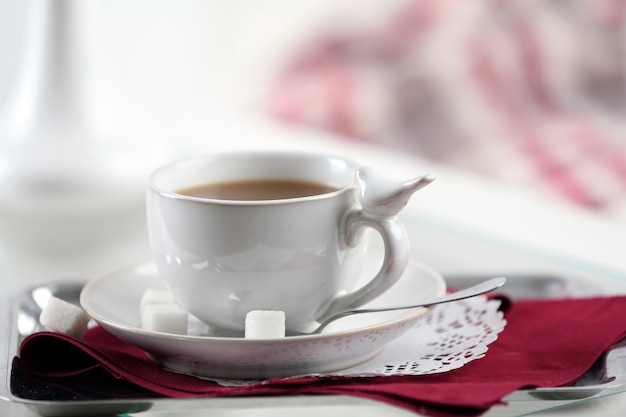 Cup of coffee on table in living room