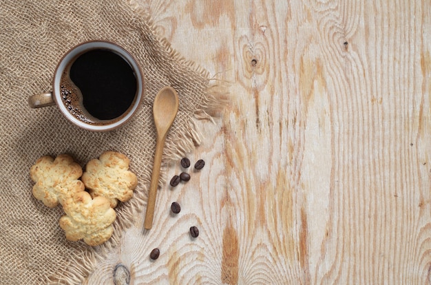 Cup of coffee and tasty biscuits with coconut chips