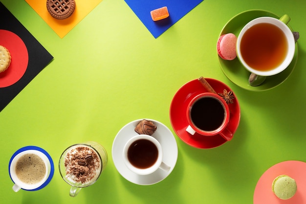 Cup of coffee, tea and cacao at colorful