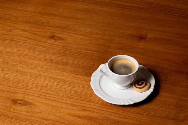 cup of coffee on top of a wooden table