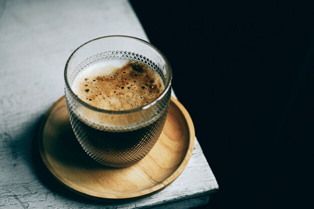 Cup of coffee on white table