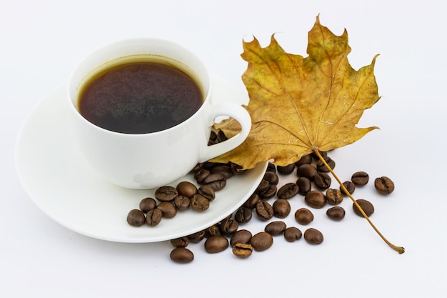 Cup of coffee with autumn maple leaf