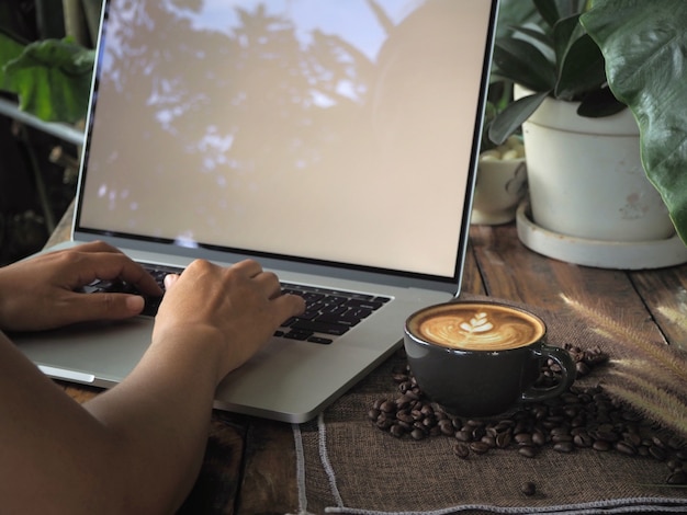 Foto tazza di caffè con bella latte art. tazza da caffè con latte art sul tavolo di legno.