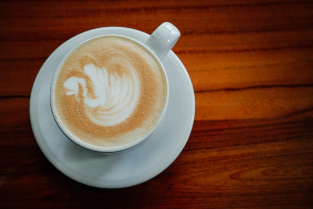 A cup of coffee with a bird on it