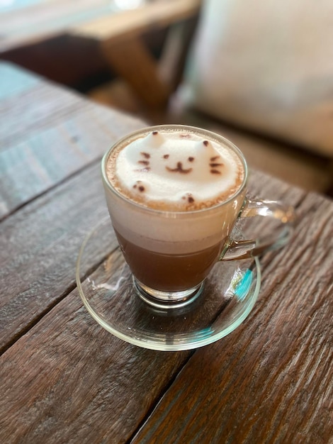 A cup of coffee with a cat face on it