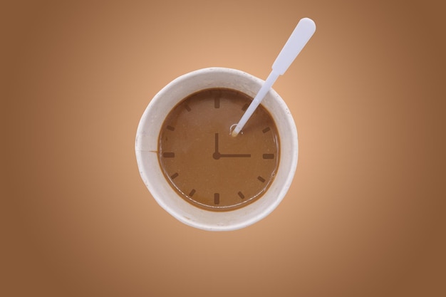 Cup of coffee with clock on brown background