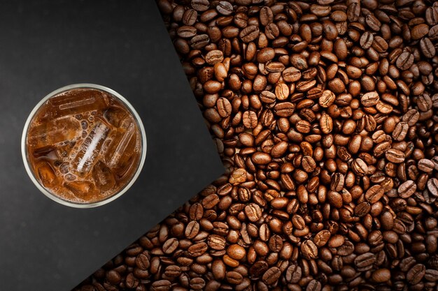 Cup of coffee with coffee beans on table