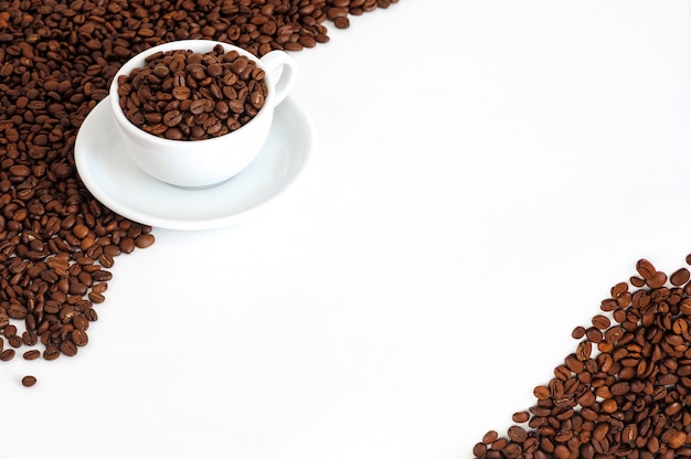 cup of coffee with coffee beans on a white