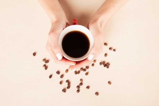 Cup of coffee with coffee beans