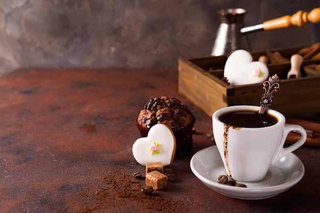 Cup of coffee with cooffee beans, wooden box with grains of coffee and spices