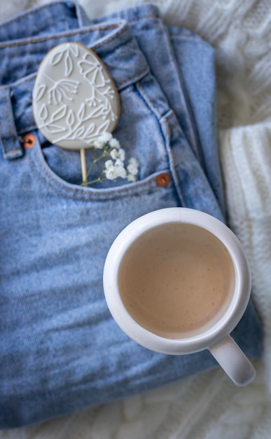 A cup of coffee with a flower on it