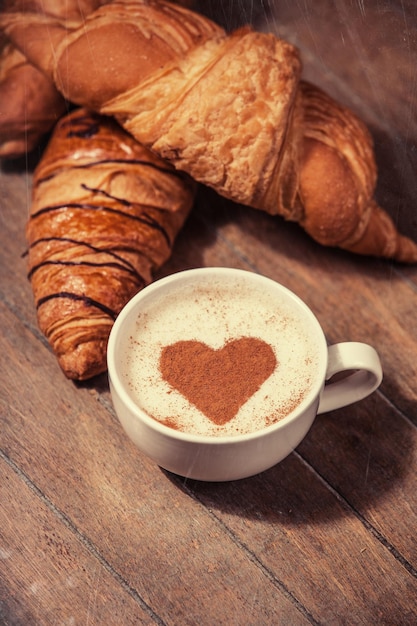 Cup of coffee with french croissant