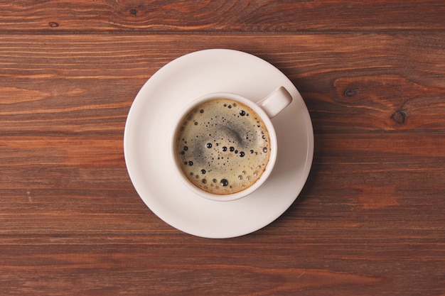 Cup of coffee with froth close up with place for text