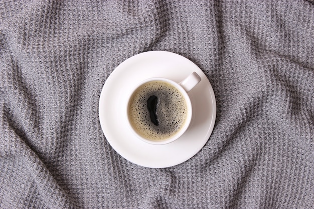 cup of coffee with froth close up with place for text
