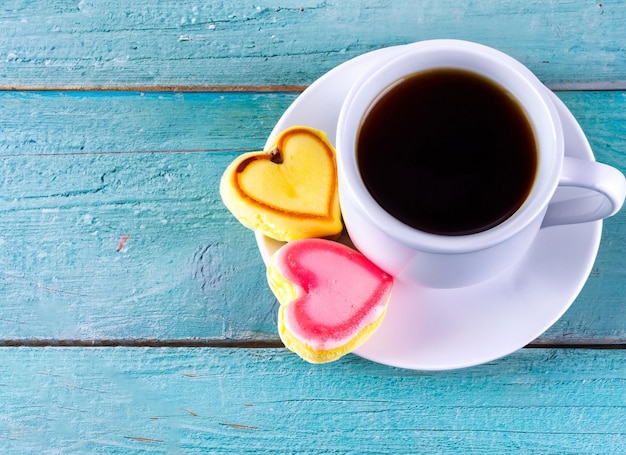 cup of coffee with a heart on a plate with cake