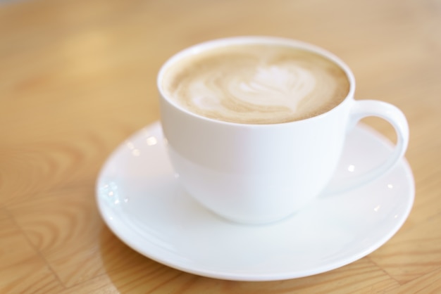 Cup of coffee with latte art pattern milk foam