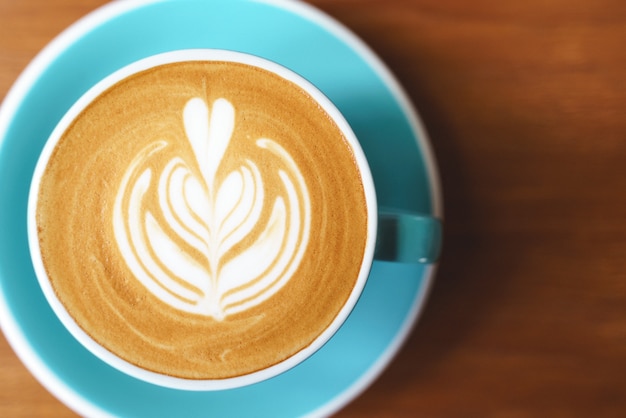 Photo cup of coffee with latte art pattern milk foam